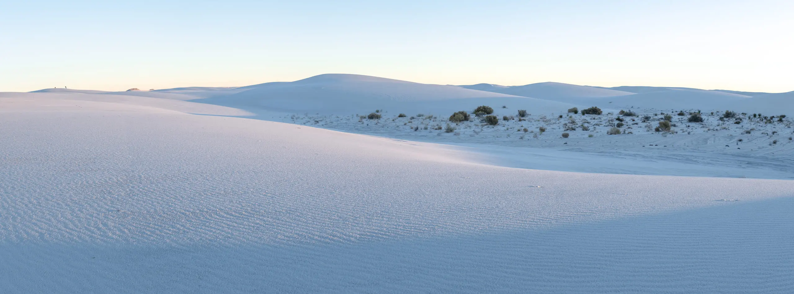 White sand dunes stretching to a low horizon
